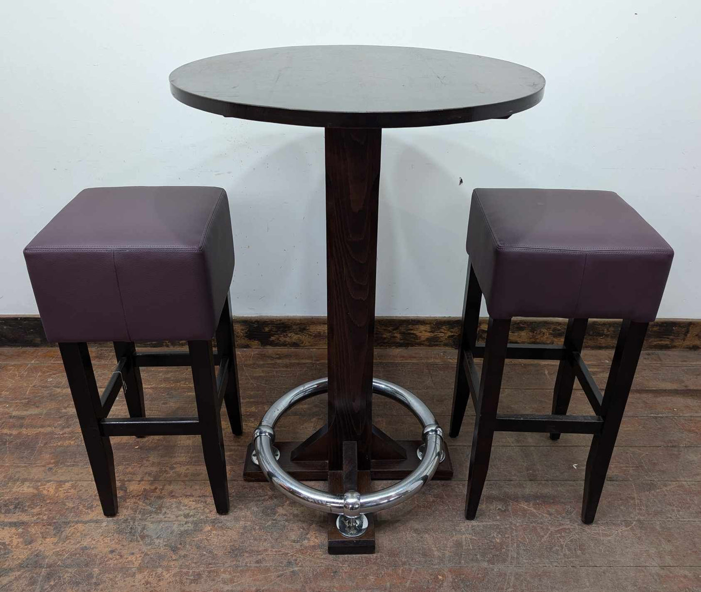 Round Poseur Table with Chrome Footbar and Two Purple Faux Leather Stools