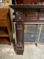 Ornate fire surround in dark wood