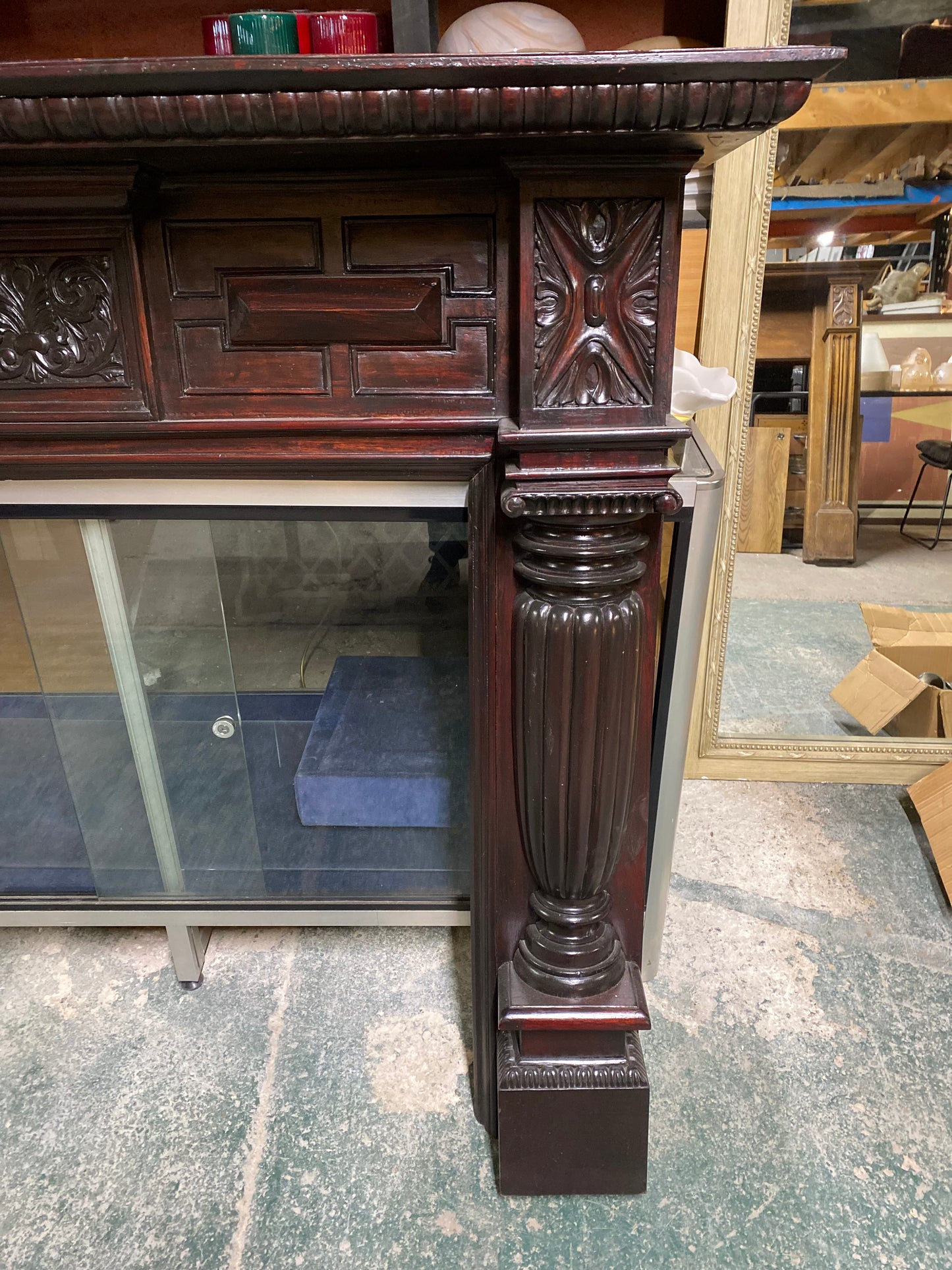 Ornate fire surround in dark wood