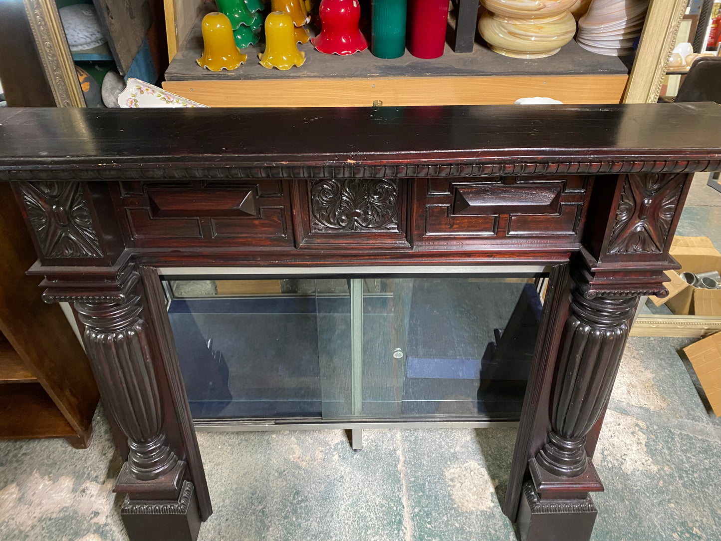 Ornate fire surround in dark wood