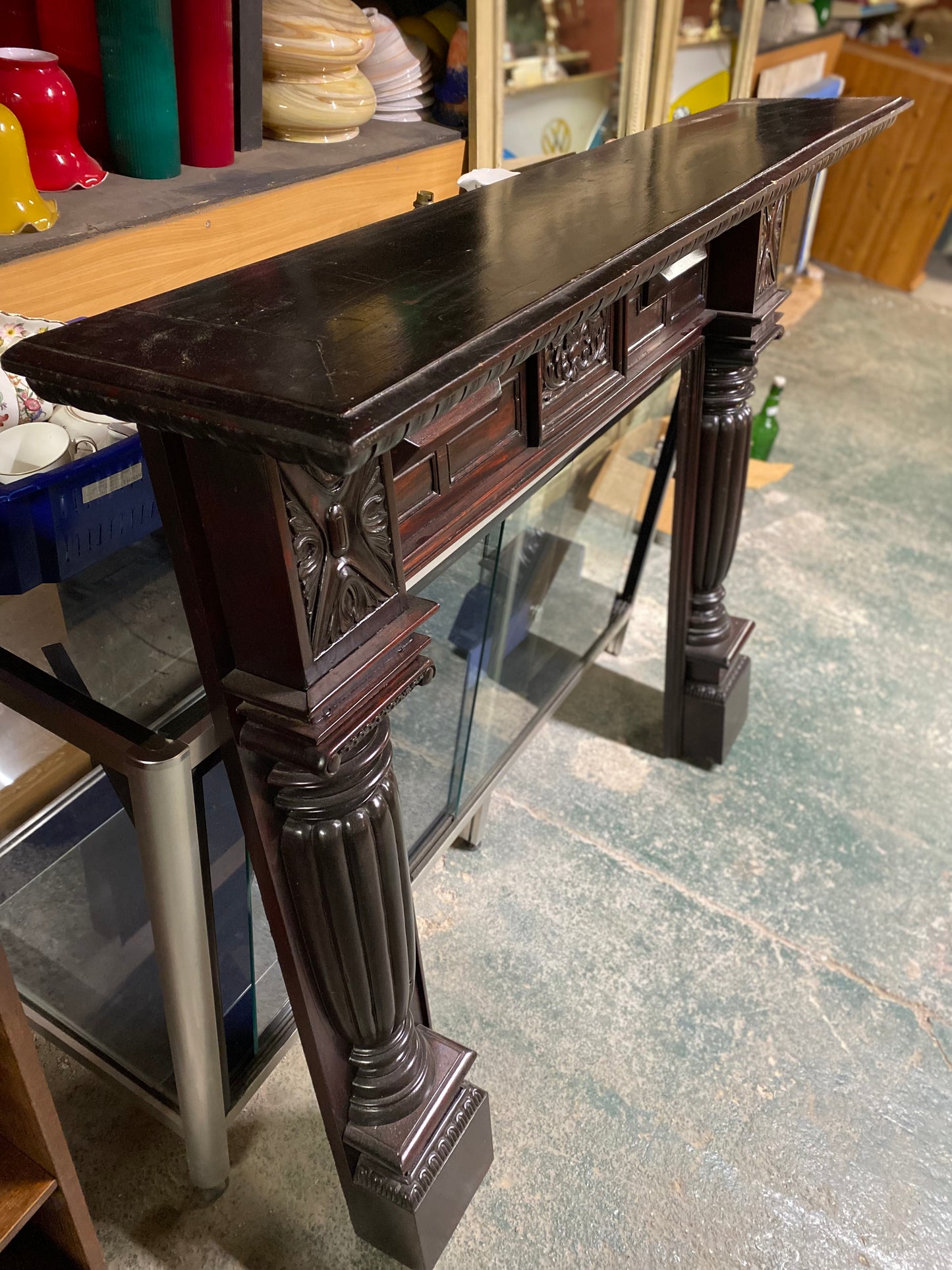 Ornate fire surround in dark wood