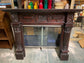 Ornate fire surround in dark wood